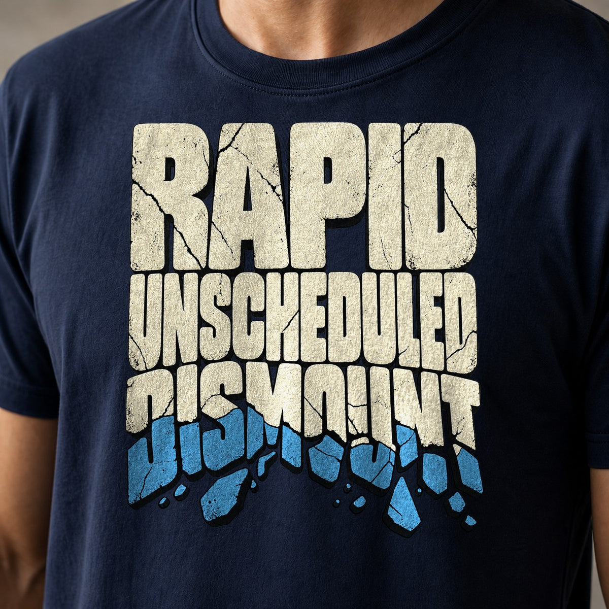 Rapid Unscheduled Dismount funny mountain bike t-shirt in Navy — Rapid Unscheduled Dismount lettering with the last word breaking into falling pieces — close-up of the print