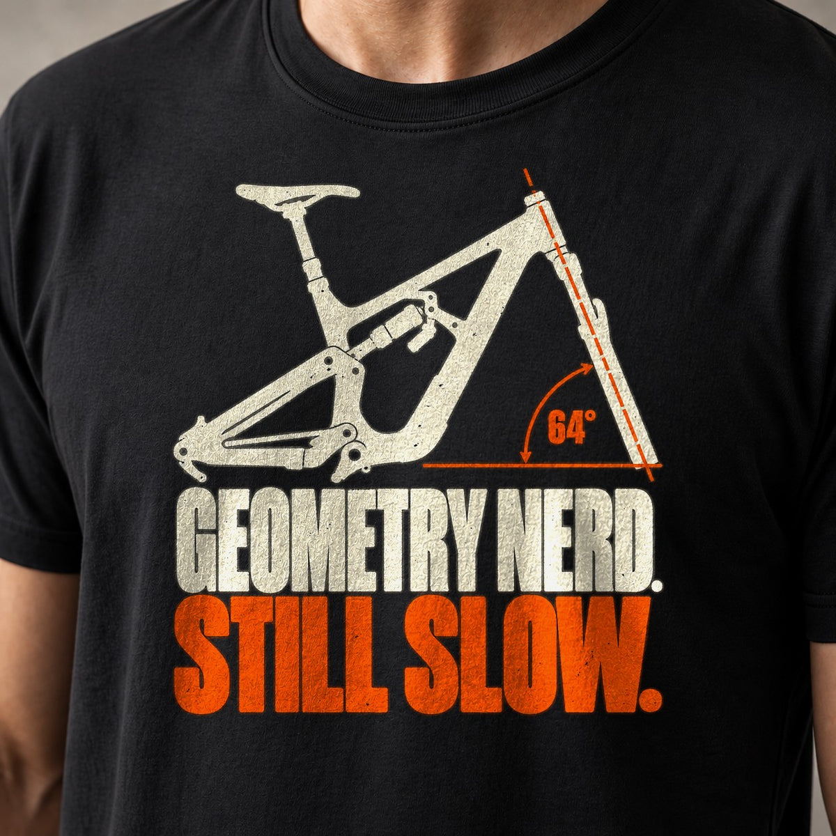 Geometry Nerd. Still Slow. funny mountain bike t-shirt in Black — full-suspension frame with the 64° head angle marked — close-up of the print