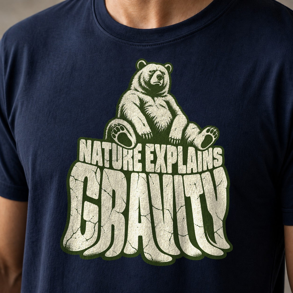 Nature Explains Gravity funny mountain bike t-shirt in Navy — bear sitting on top of sagging Gravity letters under Nature Explains text — close-up of the print