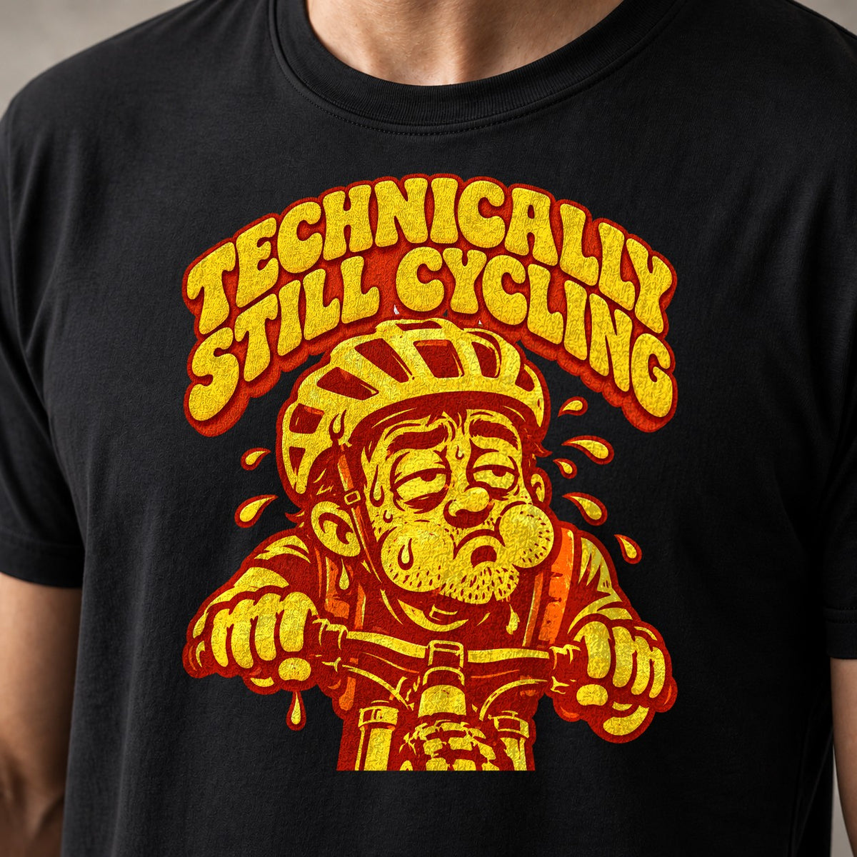 Technically Still Cycling mountain bike t-shirt in Black — exhausted cartoon rider dripping sweat over the bars — close-up of the print