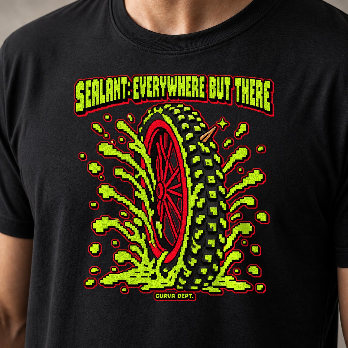 Sealant: Everywhere But There mountain bike t-shirt in Black — 8-bit tire spraying neon-green sealant everywhere but the hole — close-up of the print