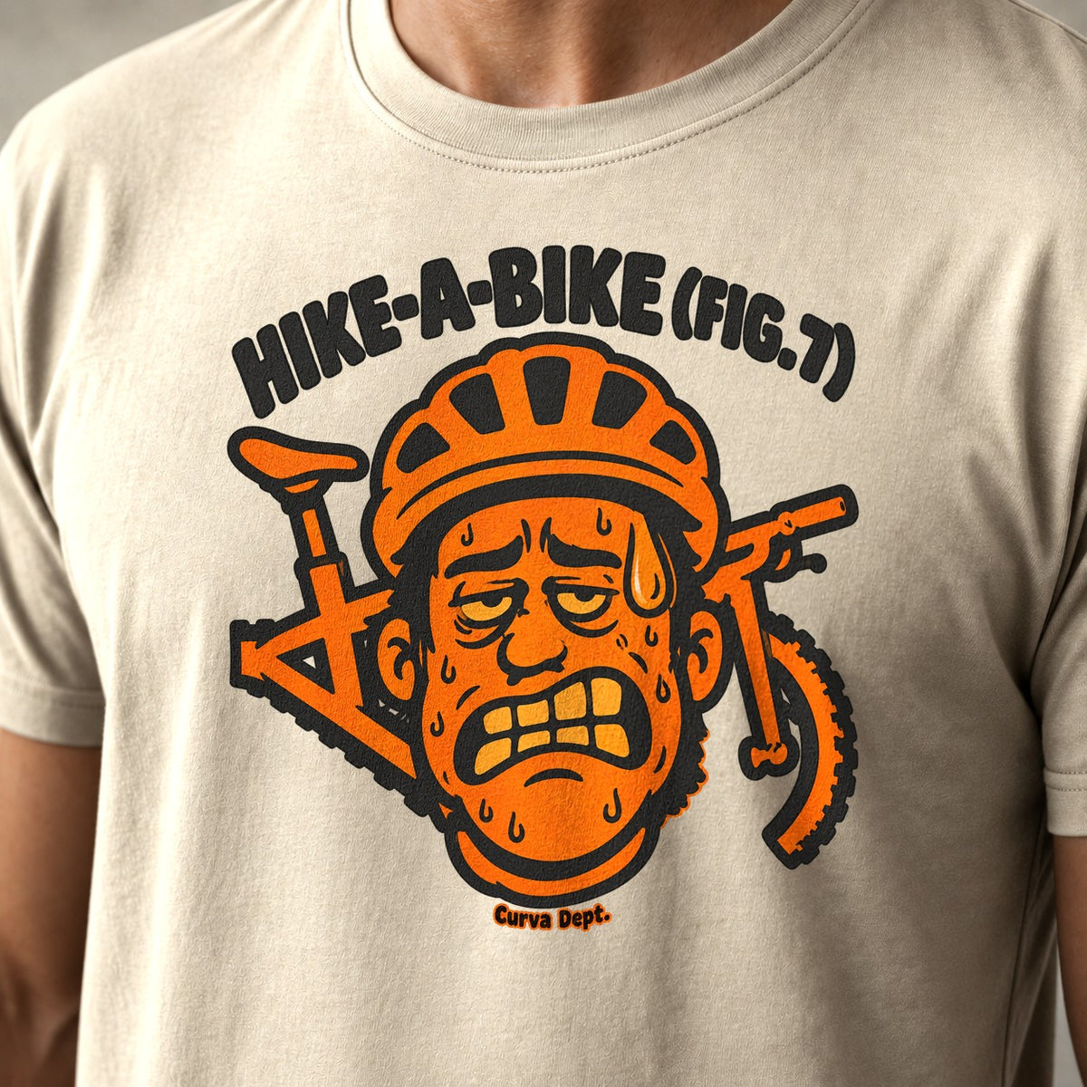 Hike-A-Bike (Fig. 7) mountain bike t-shirt in Natural — grimacing cartoon rider in an orange helmet with the bike behind his head — close-up of the print