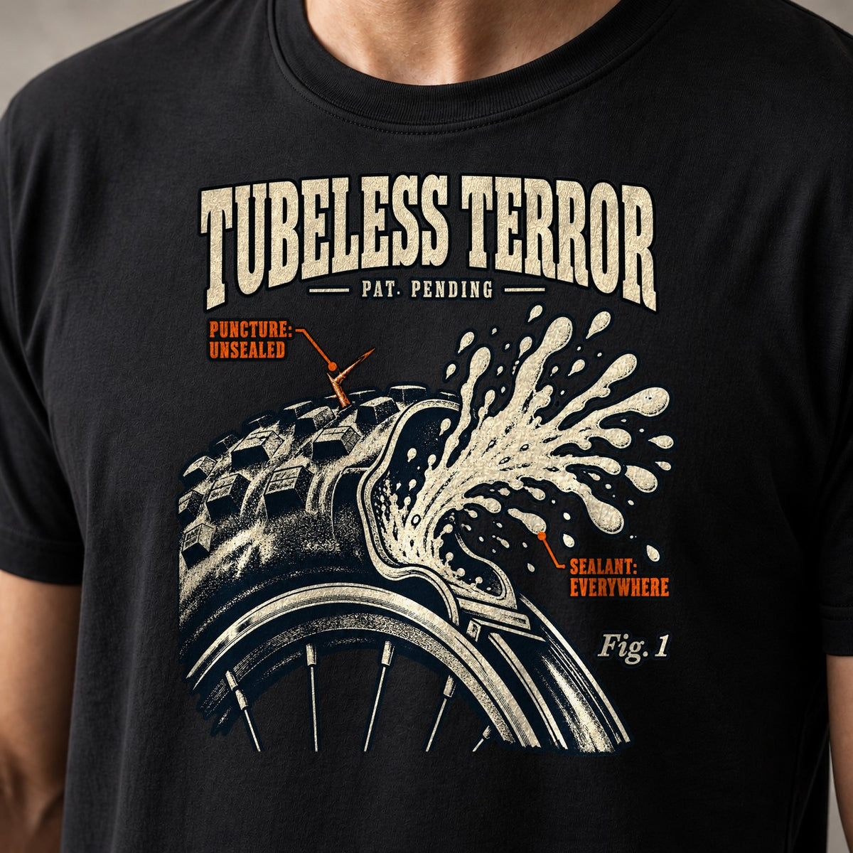 Tubeless Terror funny mountain bike t-shirt in Black — vintage patent drawing of a tubeless tire spraying sealant, labelled Fig. 1 — close-up of the print