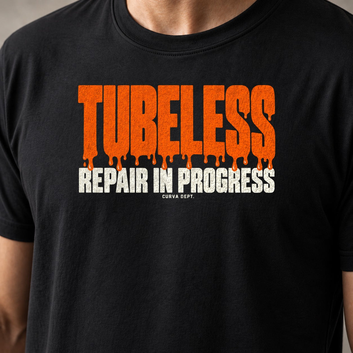 Tubeless. Repair In Progress. mountain bike t-shirt in Black — big orange block letters dripping sealant — close-up of the print