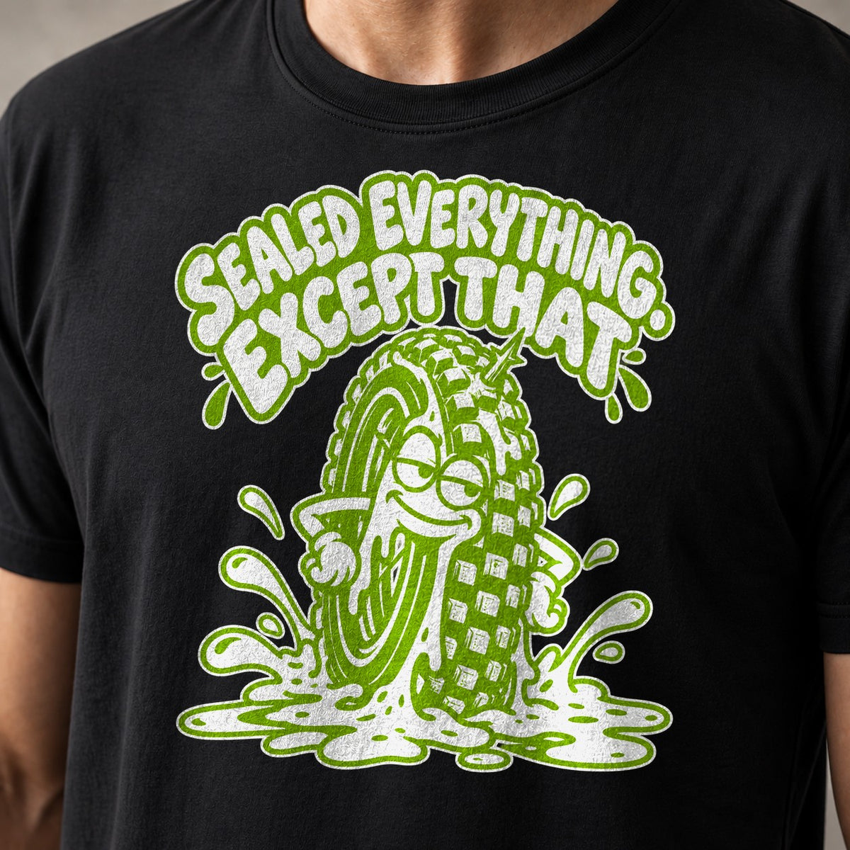 Sealed Everything. Except That. funny mountain bike t-shirt in Black — smug cartoon tire sitting in a puddle of sealant — close-up of the print