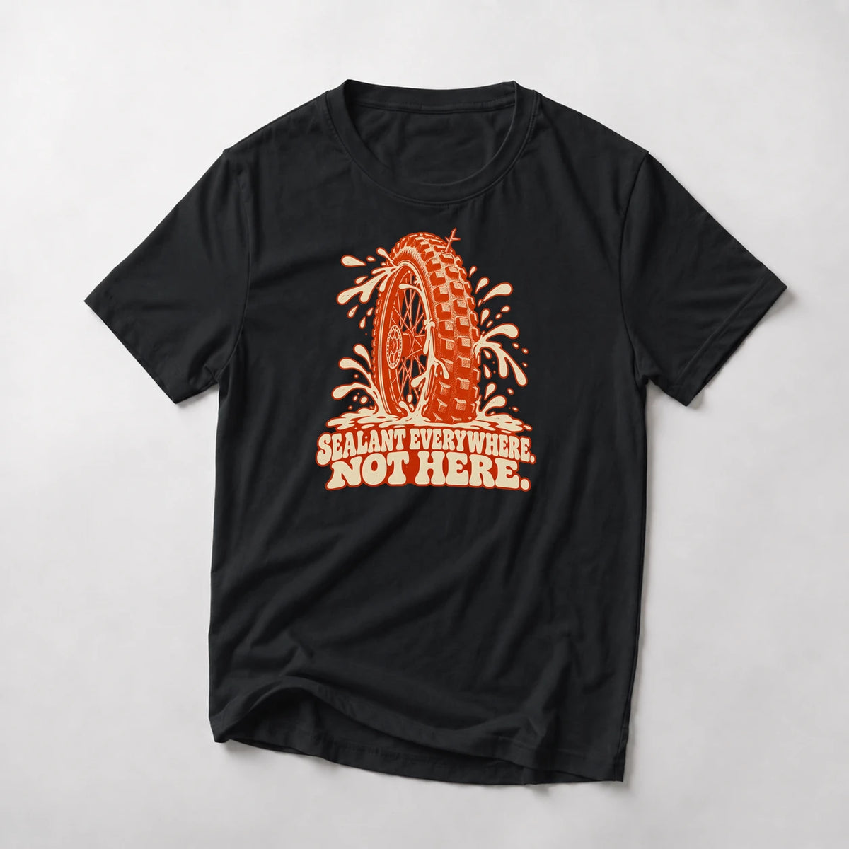 Sealant Everywhere. Not Here. funny mountain bike t-shirt in Black — knobby tire spraying sealant in every direction