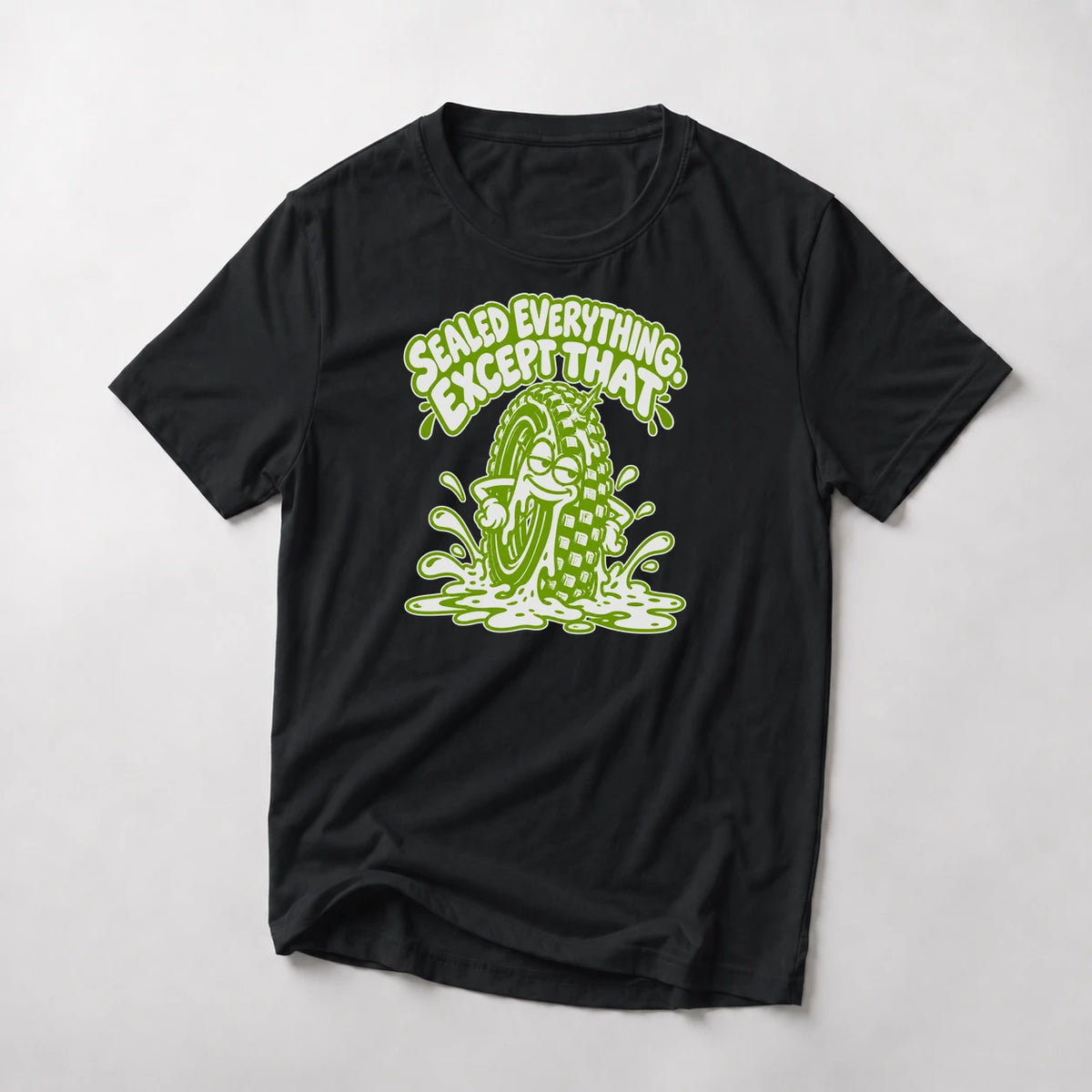 Sealed Everything. Except That. funny mountain bike t-shirt in Black — smug cartoon tire sitting in a puddle of sealant