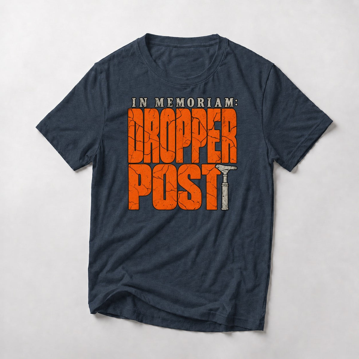 In Memoriam: Dropper Post mountain bike t-shirt in Heather Navy — cracked orange letters with a worn dropper post as the T
