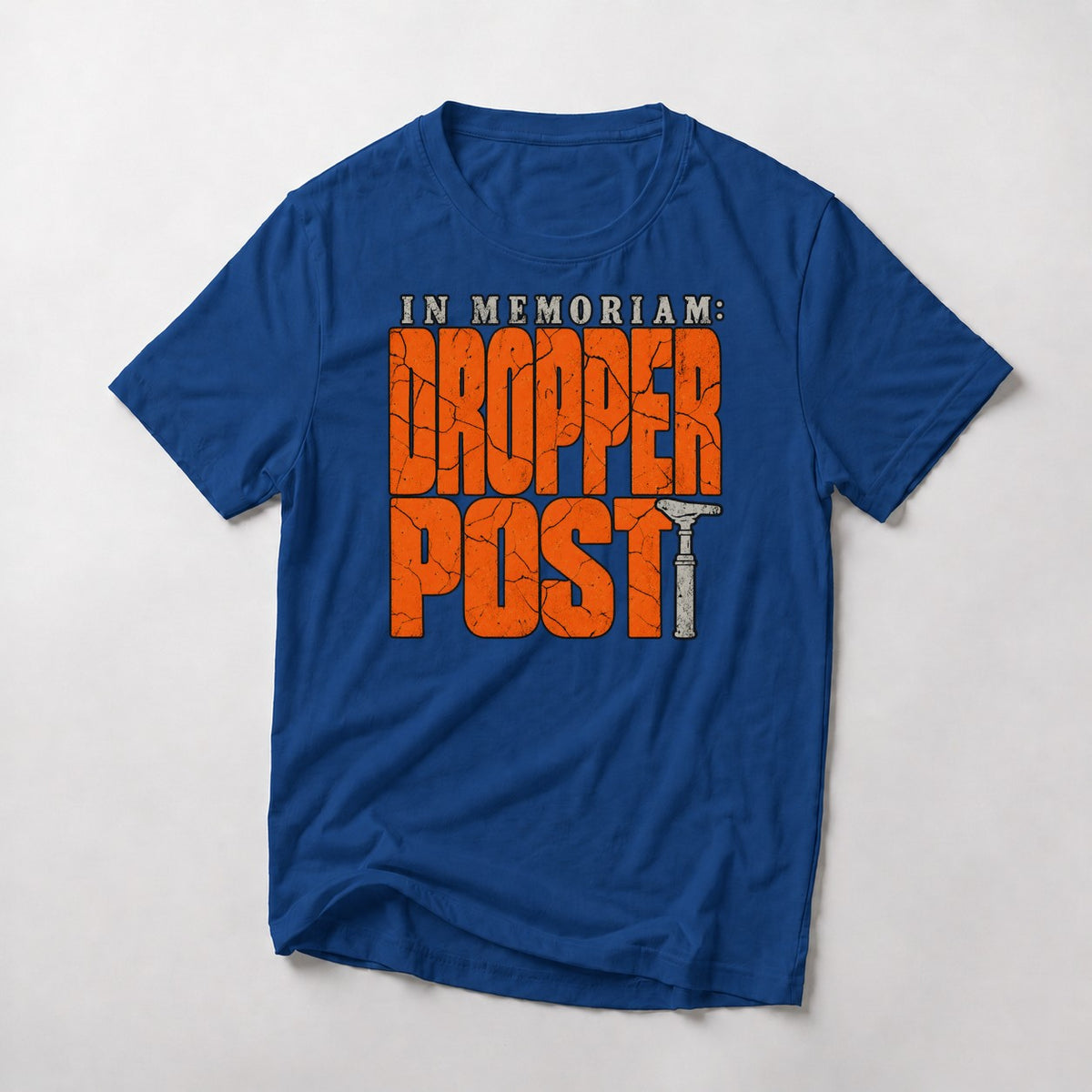 In Memoriam: Dropper Post mountain bike t-shirt in Royal — cracked orange letters with a worn dropper post as the T