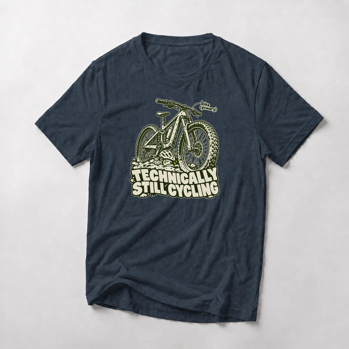 Technically Still Cycling funny mountain bike t-shirt in Navy — chunky fat-tire trail bike on a pile of rocks