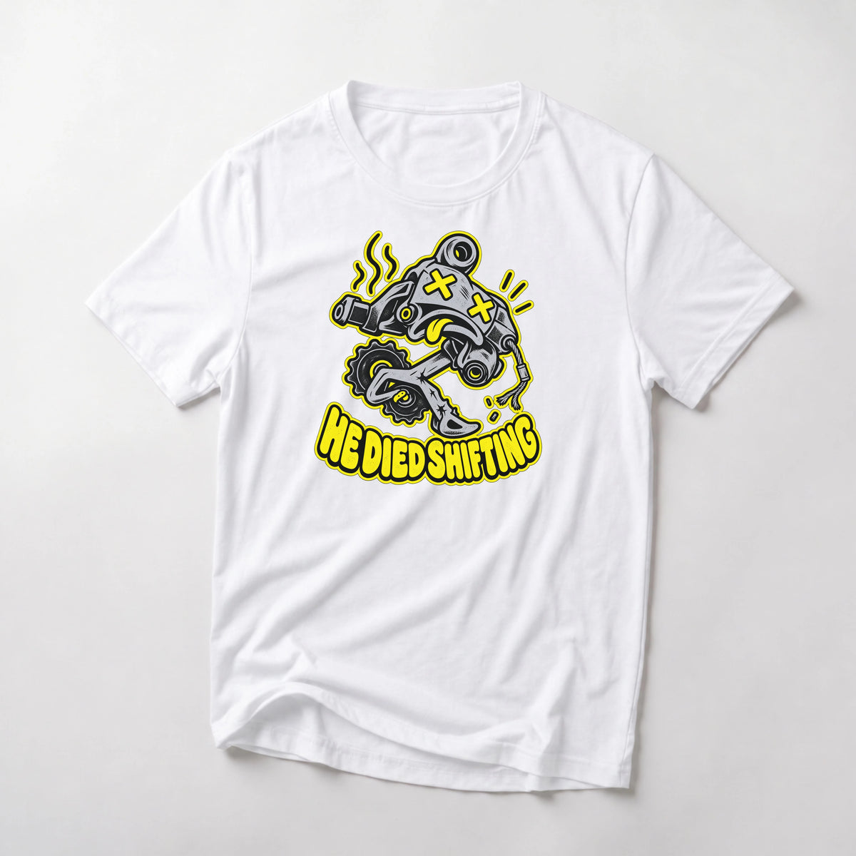He Died Shifting funny mountain bike t-shirt in White — cartoon rear derailleur with X eyes and snapped cable above He Died Shifting text