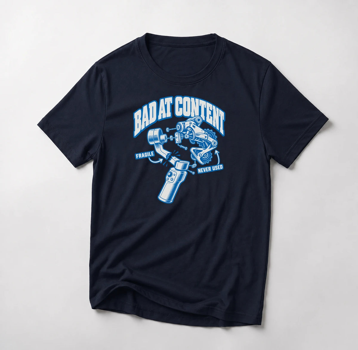 Bad At Content funny mountain bike t-shirt in Navy — exploded diagram of a phone gimbal and rear derailleur labeled Fragile and Never Used under Bad At Content