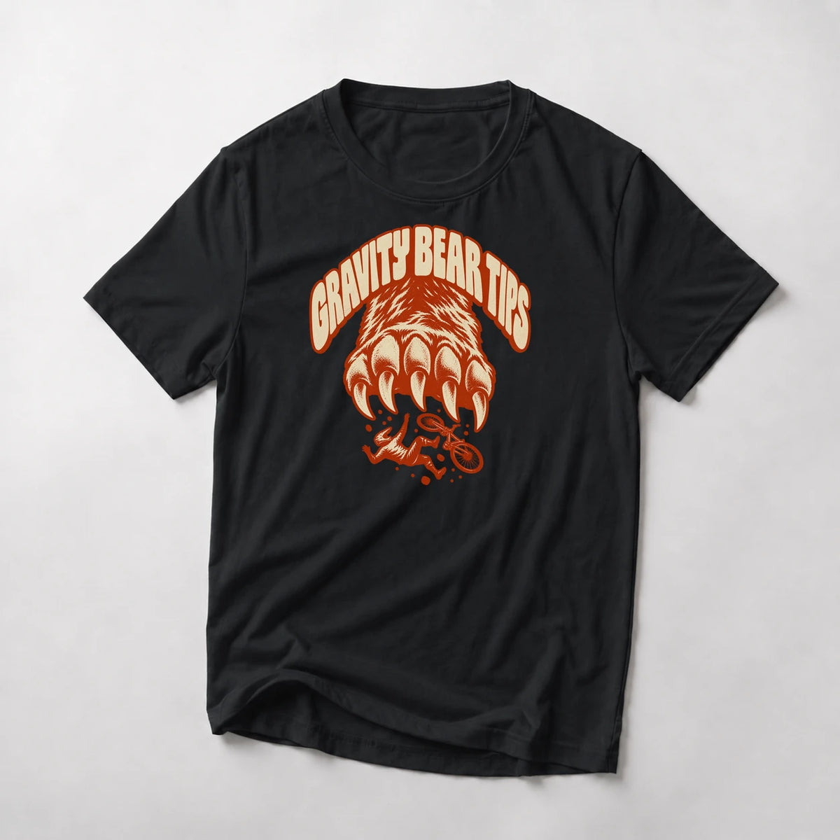 Gravity Bear Tips funny mountain bike t-shirt in Black — giant bear paw with claws above a small tumbling mountain biker under Gravity Bear Tips