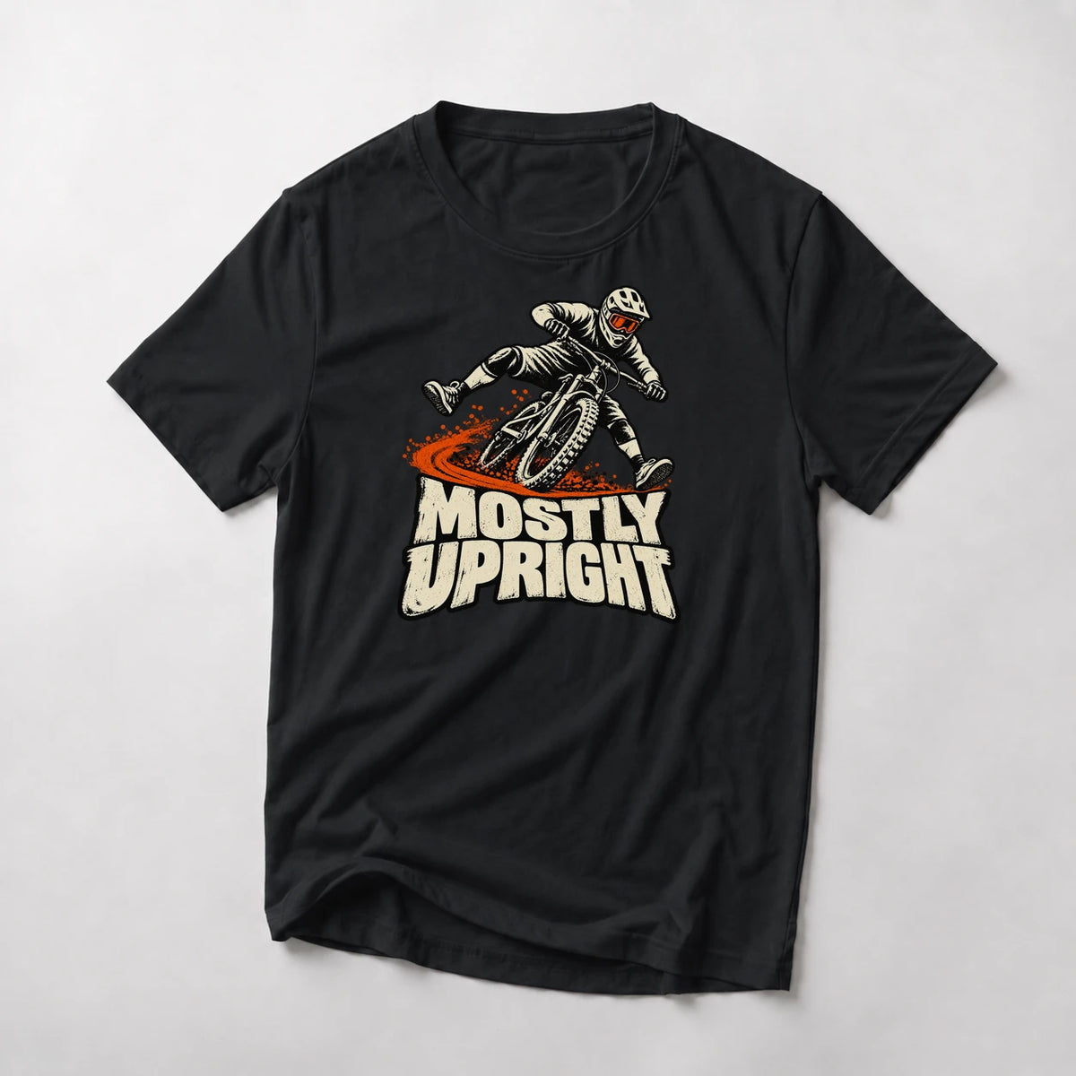 Mostly Upright funny mountain bike t-shirt in Black — mountain biker leaning mid-save with front wheel washing out above Mostly Upright