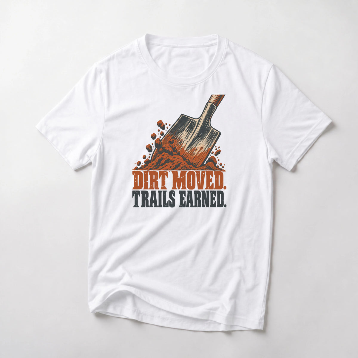 Dirt Moved. Trails Earned. funny mountain bike t-shirt in White — trail shovel driven into a pile of dirt above Dirt Moved Trails Earned