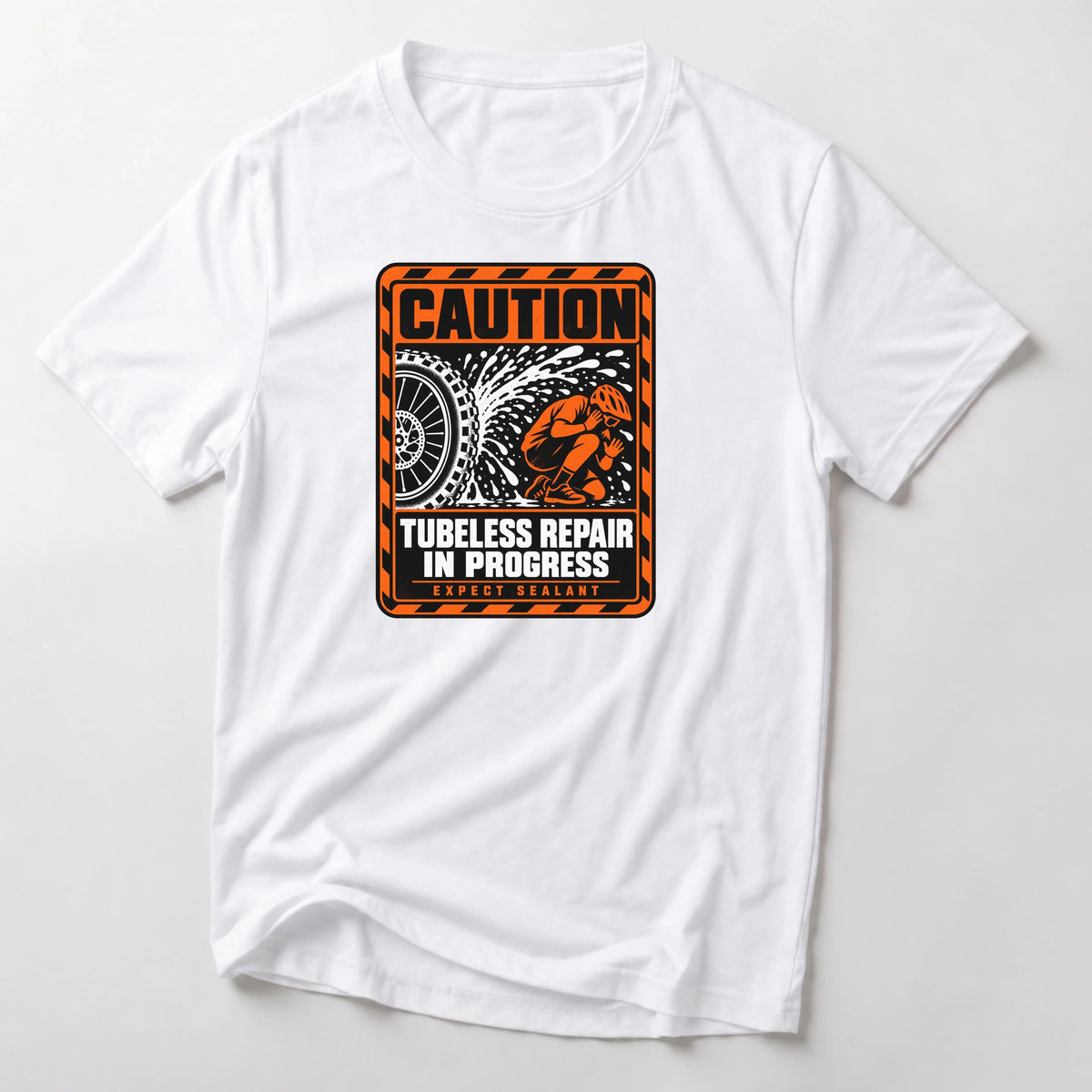 Caution Tubeless Repair In Progress funny mountain bike t-shirt in White — orange hazard sign with a tire spraying sealant at a crouching rider