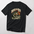 Hike-A-Bike Dept. retro cartoon mountain bike t-shirt in Black — rubber-hose rider carrying a bike on the shoulders up a rocky trail under an orange sun